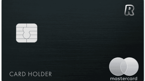 A sleek black credit card from Revolut Bank features a silver microchip on the left, with logos in the top and bottom right. The words "Card Holder" are elegantly placed near the bottom left, reflecting modern financial elegance.