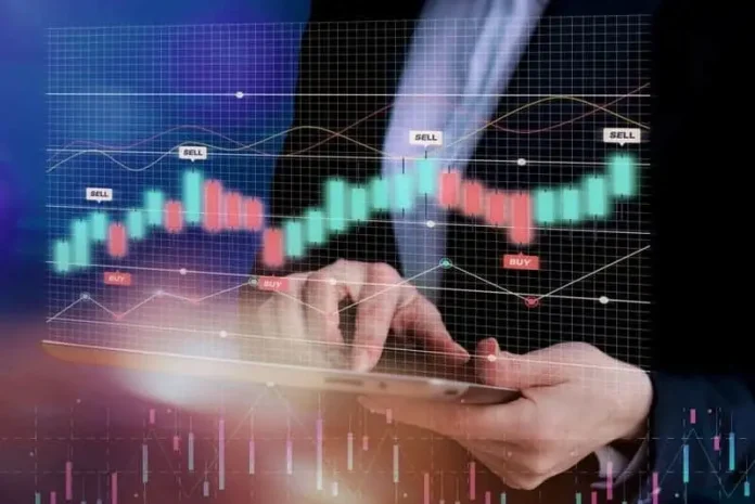 A Verified Crypto Trader uses a tablet displaying a financial trading graph with red and green candlesticks, labeled 